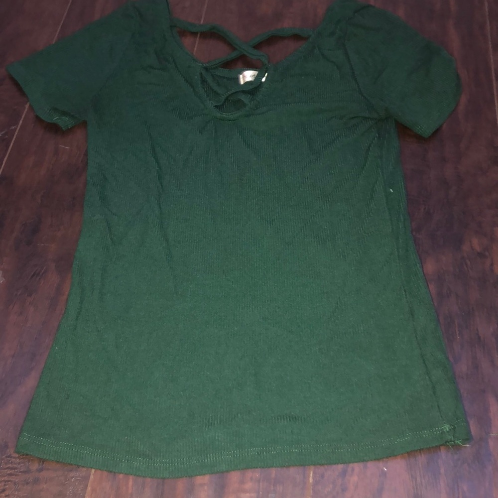 green shirt with cross on the neckline